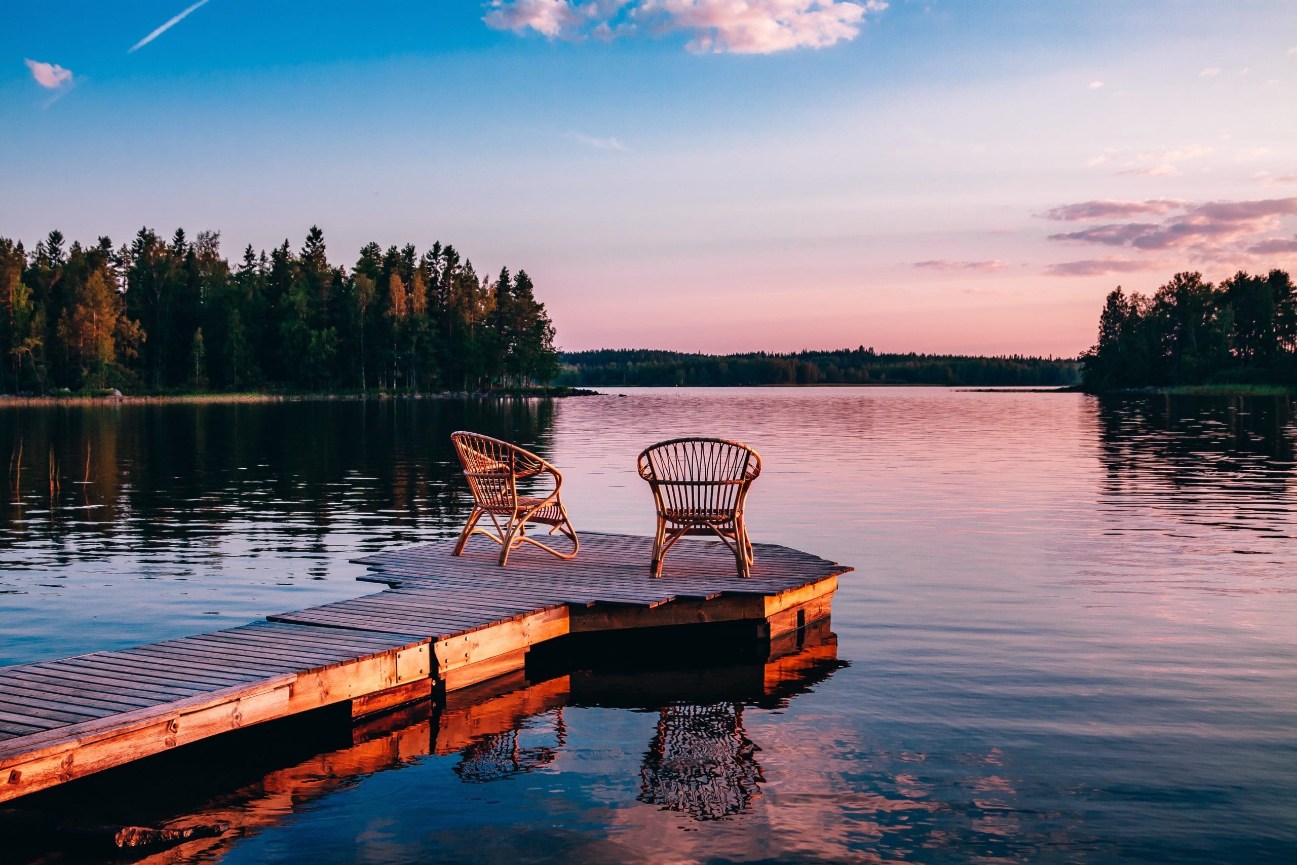 a dock at sunset looking out onto lake