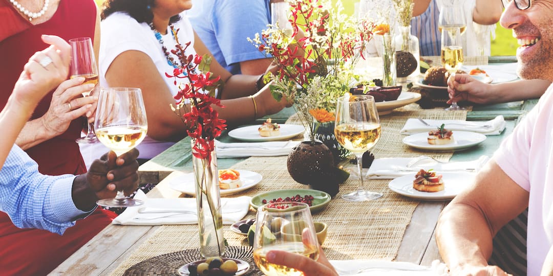 friends eating at al fresco dinner party 